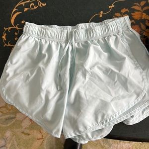 Nike dri fit running shorts in light blue, medium.